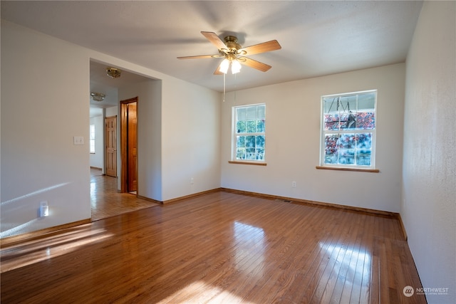 empty room featuring ceiling fan and light wood-type flooring