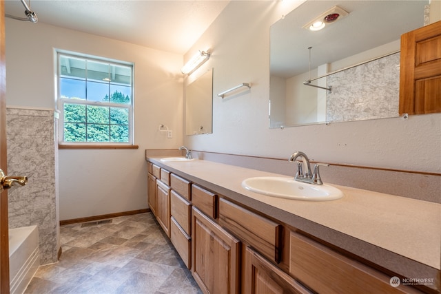 bathroom with dual vanity and tile floors