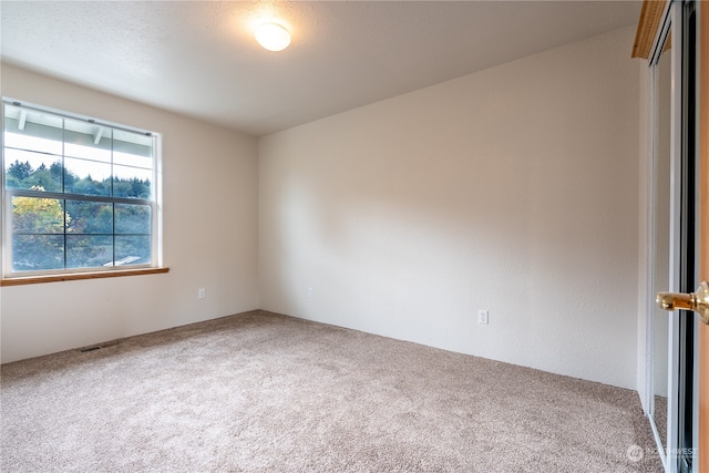 unfurnished room with carpet flooring