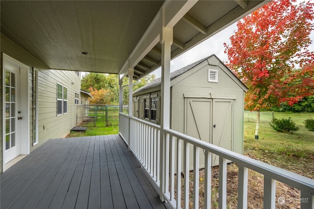 deck featuring a lawn and a storage shed