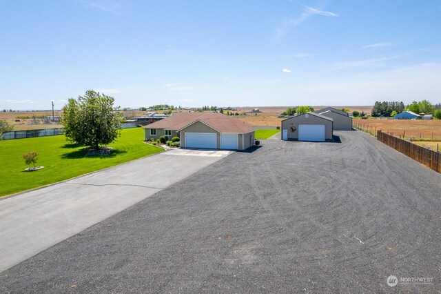 view of front of property with a water view, a front lawn, and a garage