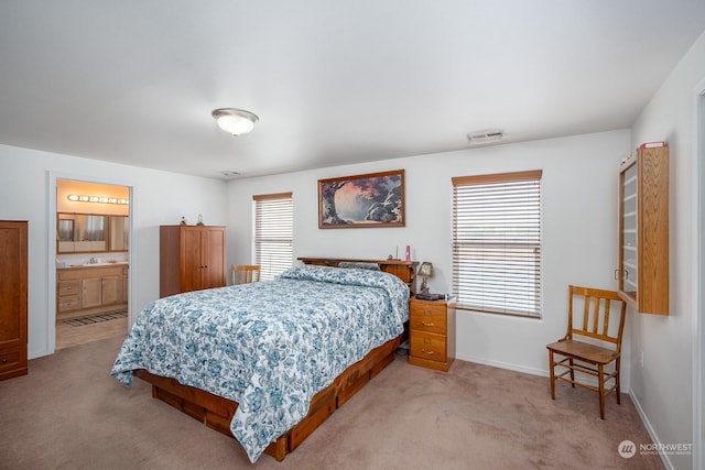 carpeted bedroom with connected bathroom