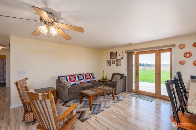 living room featuring ceiling fan and light wood-type flooring