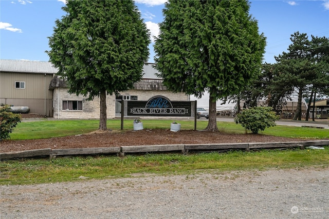 community / neighborhood sign with a yard