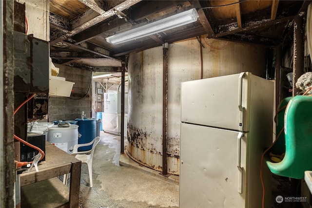 basement with white refrigerator