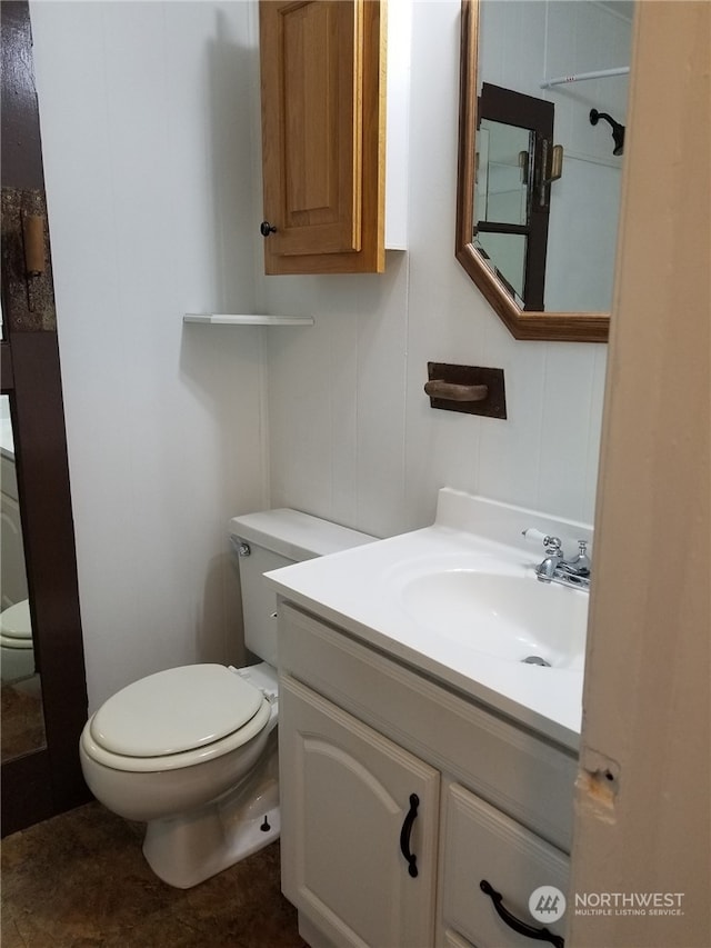 bathroom featuring toilet and vanity