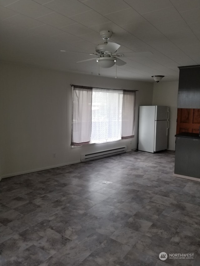 spare room featuring ceiling fan and a baseboard radiator