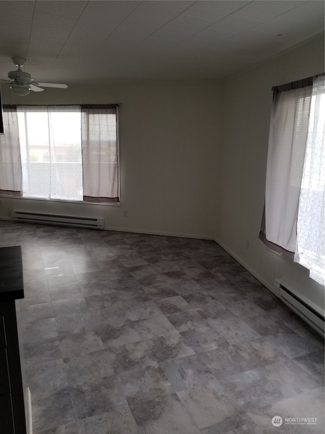 unfurnished room with ceiling fan and baseboard heating