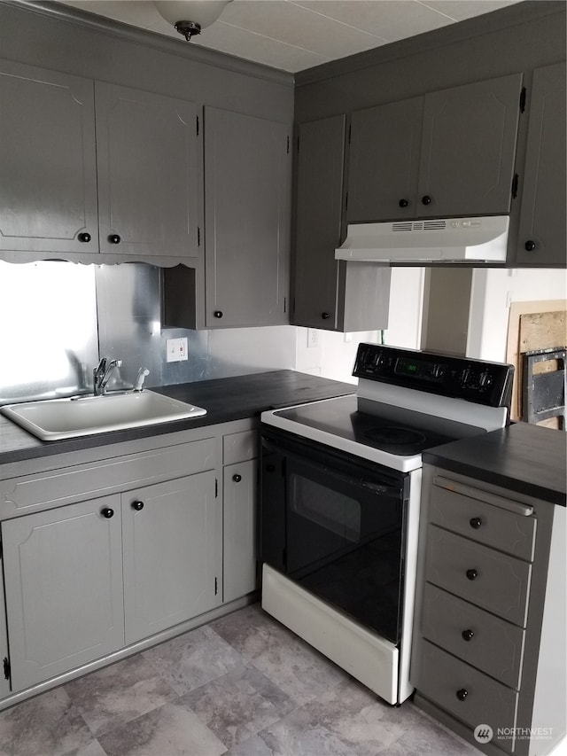 kitchen featuring white electric range, gray cabinetry, tasteful backsplash, and sink