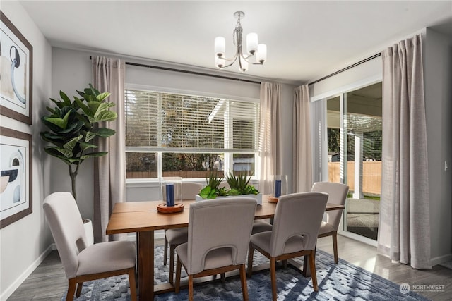 dining room featuring an inviting chandelier and dark wood-type flooring