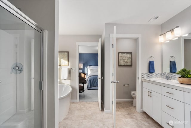 bathroom featuring vanity, toilet, and a shower with door