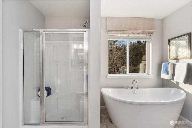 bathroom featuring independent shower and bath