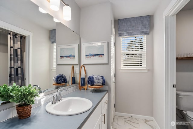 bathroom featuring toilet and vanity