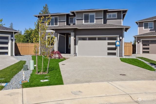 prairie-style home with a garage and a front yard