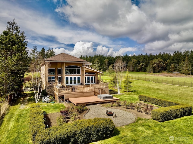 rear view of house with a yard and a wooden deck