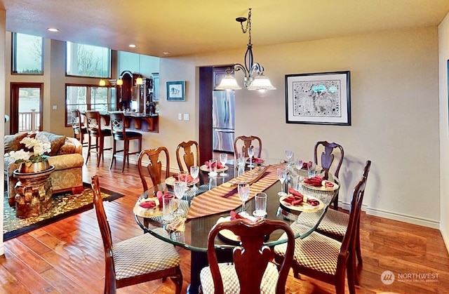 dining area featuring a chandelier and light hardwood / wood-style floors