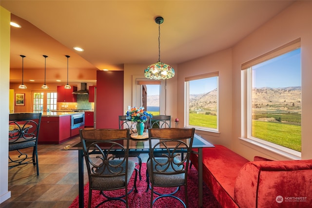 tiled dining room featuring a healthy amount of sunlight