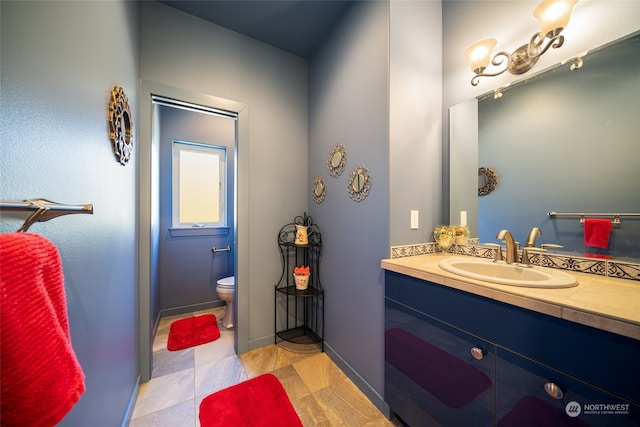 bathroom featuring large vanity and toilet