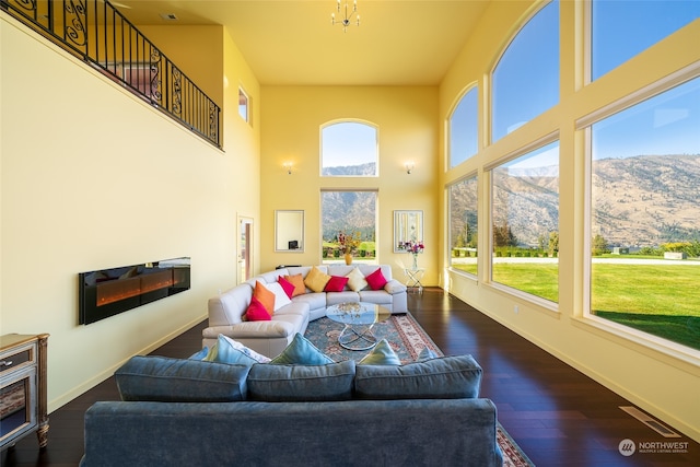 sunroom with a mountain view, an inviting chandelier, and a wealth of natural light