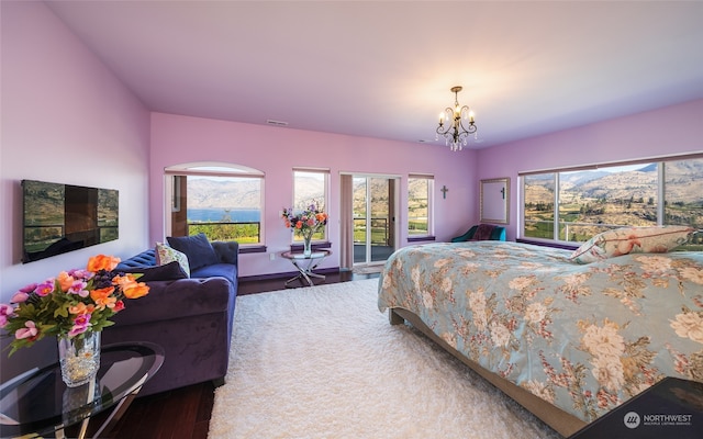 bedroom featuring a notable chandelier and dark hardwood / wood-style floors