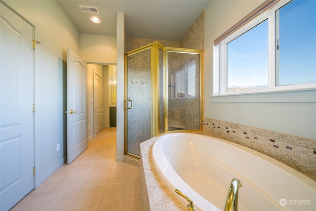 bathroom featuring plus walk in shower and tile flooring