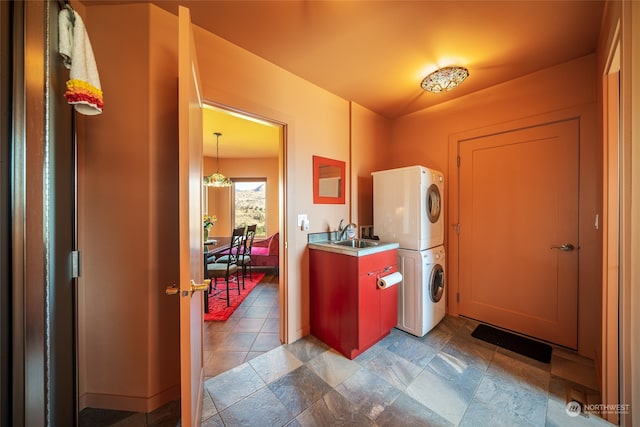 interior space featuring sink, light tile floors, and stacked washer / dryer