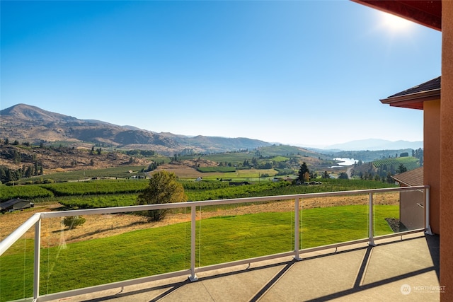 balcony featuring a mountain view and a rural view