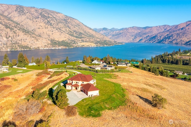 birds eye view of property with a water and mountain view