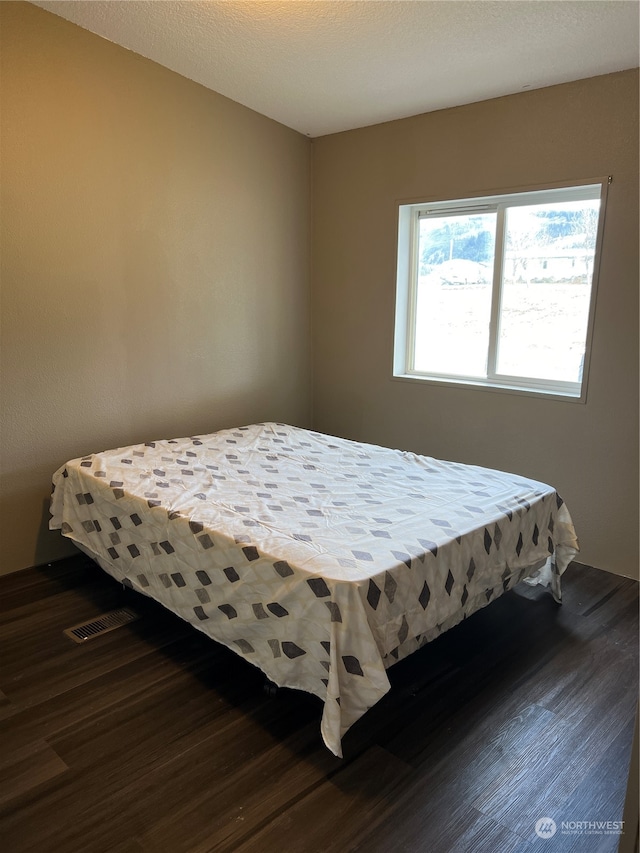 bedroom featuring dark wood-type flooring