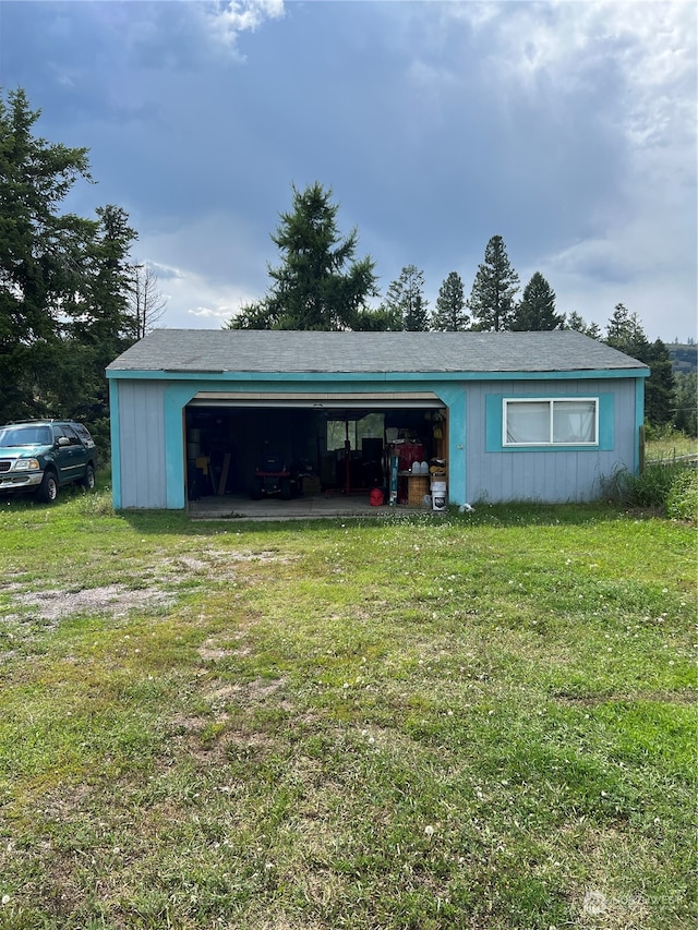 garage featuring a lawn