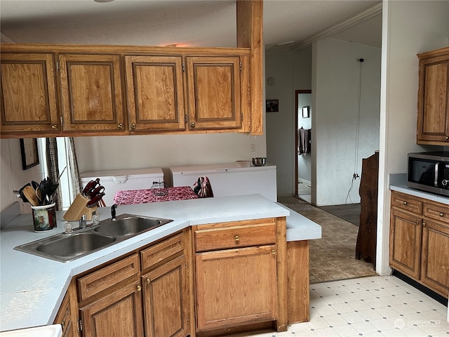 kitchen featuring sink and light tile floors