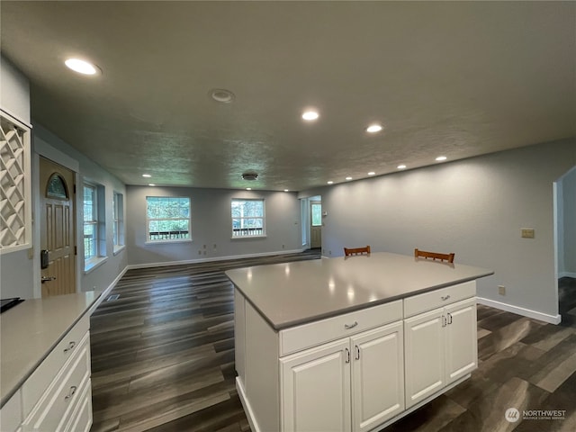 653 Sunset Ave NE, Ocean Shores, WA 98569 - kitchen featuring white cabinets, a kitchen island, and dark hardwood / wood-style flooring