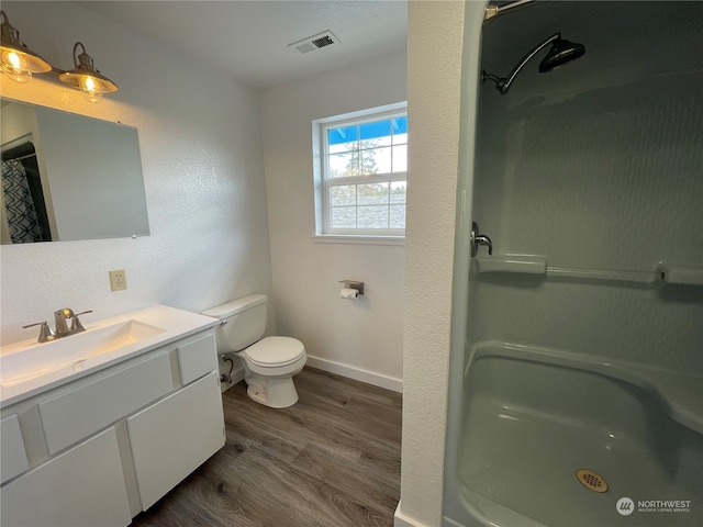 653 Sunset Ave NE, Ocean Shores, WA 98569 - bathroom featuring vanity, hardwood / wood-style floors, and toilet
