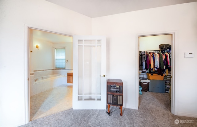 carpeted bedroom with a closet and a walk in closet