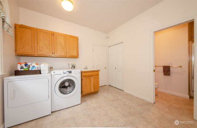 laundry room with washer hookup, washer and clothes dryer, cabinets, and light tile floors