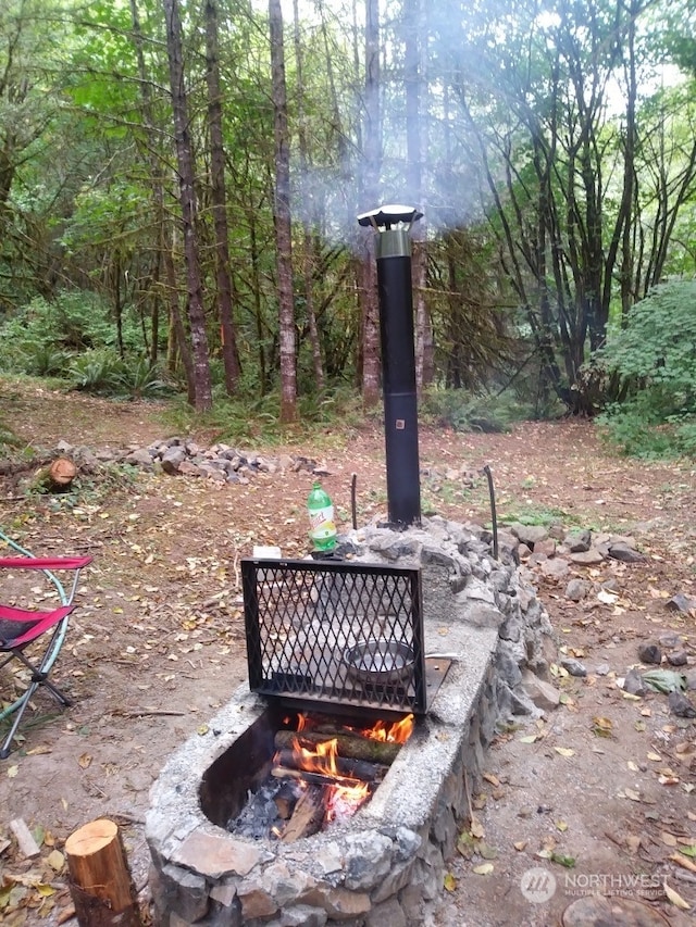 exterior details featuring an outdoor fire pit