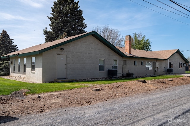 view of home's exterior featuring a yard and central AC unit