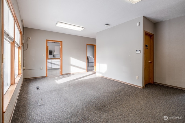 empty room featuring dark colored carpet