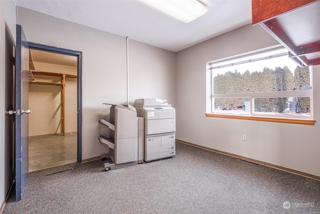 unfurnished bedroom featuring light carpet and a walk in closet