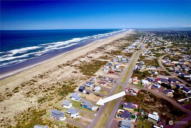 birds eye view of property featuring a water view and a view of the beach