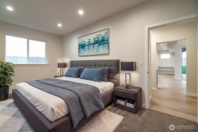 bedroom featuring baseboards, wood finished floors, and recessed lighting