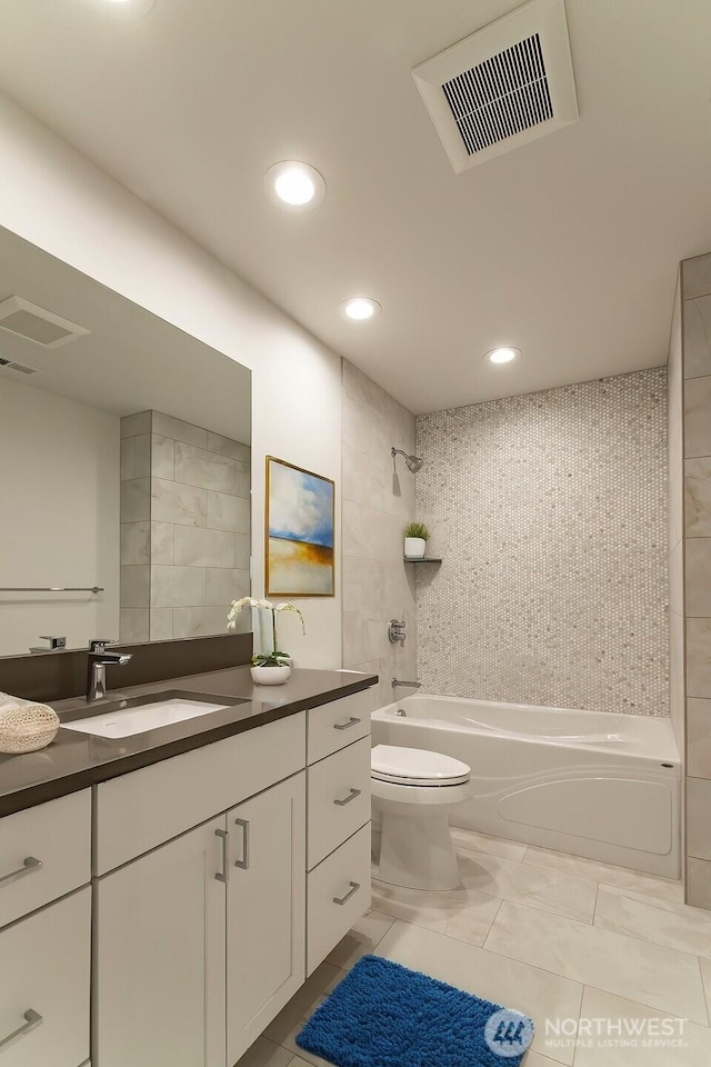 bathroom featuring toilet, bathing tub / shower combination, vanity, and visible vents