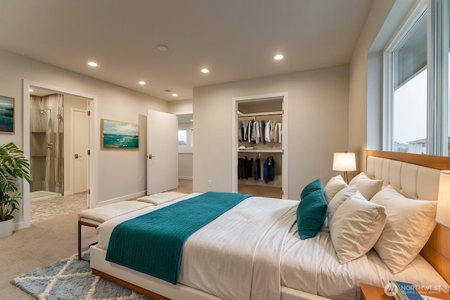 bedroom with carpet floors, baseboards, a walk in closet, and recessed lighting