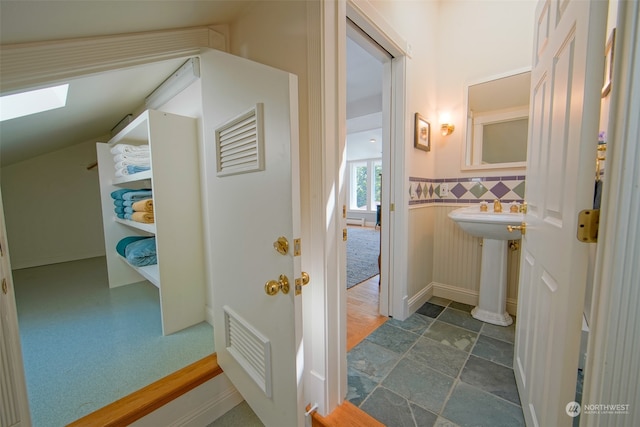 bathroom with a skylight and visible vents