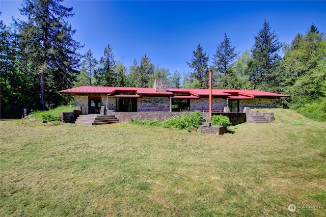 rear view of house with a yard