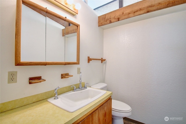 bathroom featuring toilet and vanity