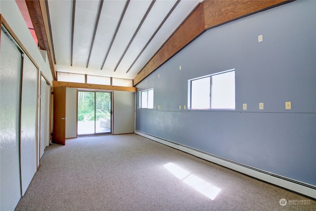 carpeted spare room featuring vaulted ceiling with beams and a baseboard heating unit