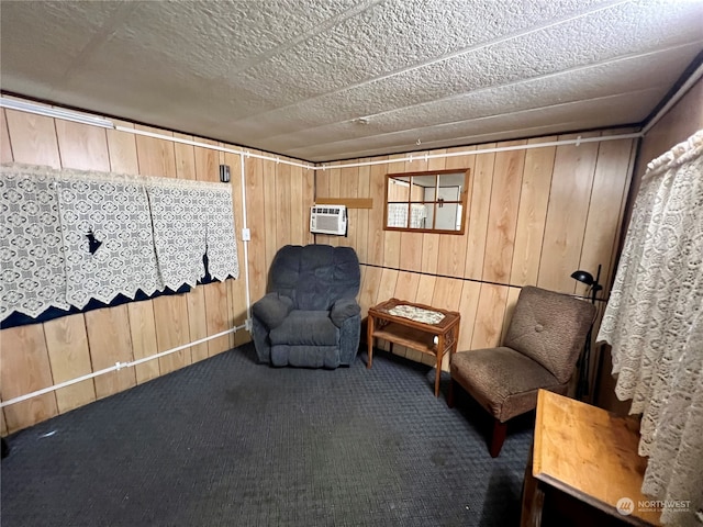 unfurnished room featuring wooden walls, a wall mounted AC, and dark carpet