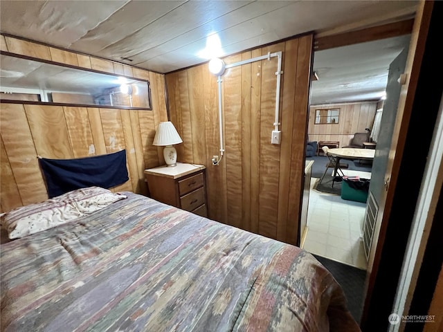 bedroom featuring wood walls