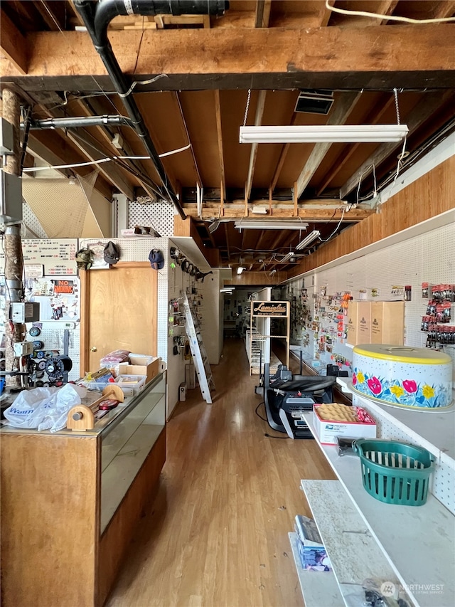 basement featuring a workshop area and light hardwood / wood-style flooring